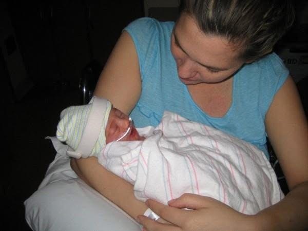 Baby Ari held close in her mother’s arms.