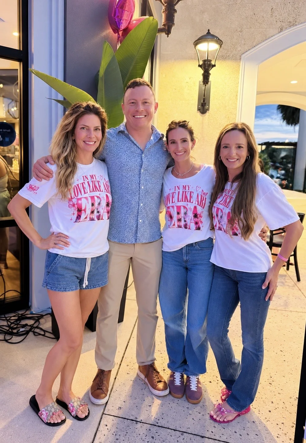 Four people outside Terra at Family Night, three of them in “In my Love Like Ari era” T-shirts.
